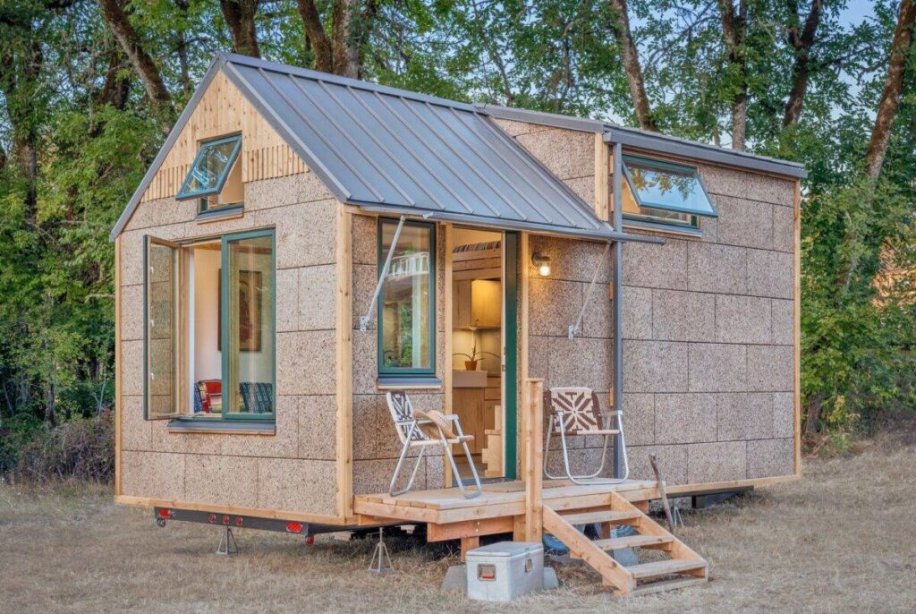 Exterior view of tiny home designed and developed by Cultivate Inc featuring cork siding, high efficiency triple paned windows and standing seam metal roof.